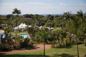 a view of a resort with a pool and palm trees at 413 BREAKERS RESORT UMHLANGA in Durban