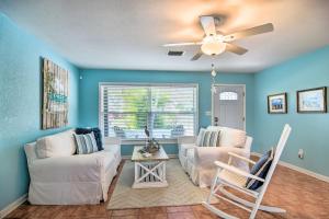 a living room with two white couches and a ceiling fan at Coral Shores Waterfront Oasis with Private Dock! in Bradenton