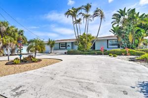 a driveway in front of a house with palm trees at Coral Shores Waterfront Oasis with Private Dock! in Bradenton
