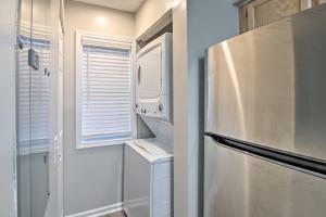 a kitchen with a refrigerator and a window at Swim, Golf, Play - Beachy River Oaks Condo! in Myrtle Beach