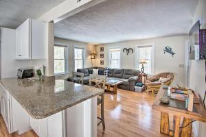 a kitchen and living room with a counter top at Gilford Home with Forest View, by Lake Winnepesaukee in Gilford