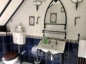 a bathroom with a toilet and a sink at Wensum House in Norwich