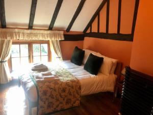 a bedroom with a bed with white sheets and green pillows at Wensum House in Norwich