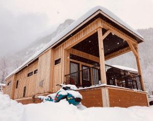 a cabin with snow on the ground in front of it at Boulder Mountain Resort in Revelstoke