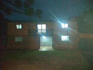 a building with two windows at night with lights at Casa de Campo - Cambará do Sul in Cambara do Sul