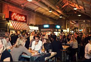 a crowd of people sitting at tables in a restaurant at Dreamtime Houseboat in Amsterdam