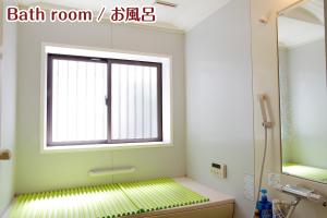 a bathroom with a window and a bath room with a shower at NIKKO stay house ARAI - Vacation STAY 14988v in Nikko