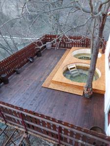 a wooden deck with a tree on top of it at Casa Pedro in Blăjani