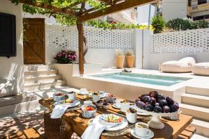 a table with food on it next to a swimming pool at Cretan Soul in Platanias