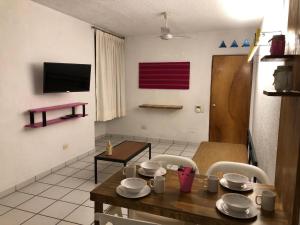 a dining room with a wooden table and chairs at Hotel Vagabundo Puerto Vallarta in Puerto Vallarta