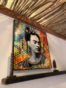 a painting of a woman on a wall at Residencial Bem-te-vi in Jericoacoara