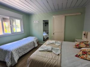 Katil atau katil-katil dalam bilik di Pousada O Canto do Sabia