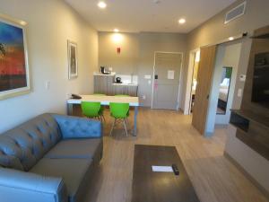 a living room with a couch and a table at Wyndham Garden College Station in College Station