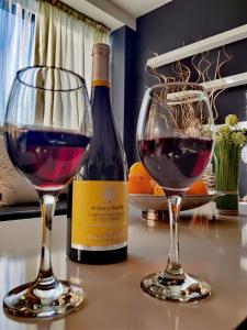 een fles wijn en twee glazen op een tafel bij Hotel Acktion in Shumen