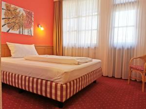 ein Hotelzimmer mit einem Bett in einem Zimmer in der Unterkunft Landhotel Ölmühle in Mömbris