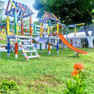 einen Spielplatz mit Rutsche und Rutsche in der Unterkunft Hotel Inversiones Napoles in Doradal