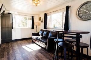 a living room with a leather couch and a table at Garden of the Gods RV Resort in Colorado Springs