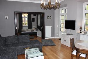 a living room with a couch and a table and a television at Casa Hauth in Bernkastel-Kues