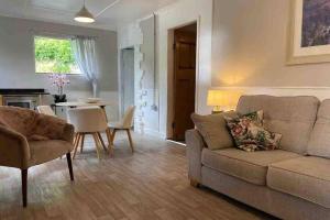 a living room with a couch and a table at Coach House in Keighley