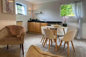 a kitchen and dining room with a table and chairs at Coach House in Keighley +15 photos