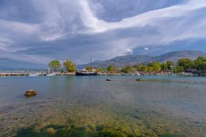 a large body of water with a boat in it at Haris Rooms in Georgioupolis