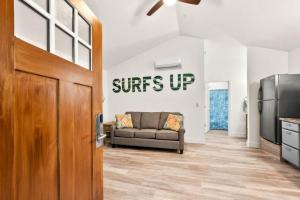 a living room with a couch and a door at Sea Cottages of Amelia in Fernandina Beach