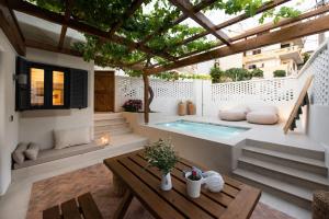a patio with a swimming pool and a pergola at Cretan Soul in Platanias