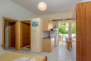 a kitchen and living room with a kitchen and a dining room at Haris Rooms in Georgioupolis +16 photos