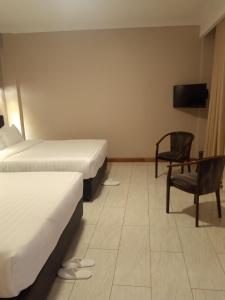 En eller flere senger på et rom på Villa Grazia Luxury Hotel