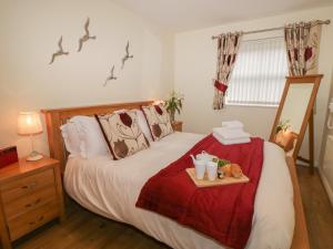 a bedroom with a bed with a tray of food on it at Cadliam in Whitby