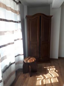 a room with a wooden cabinet and a ottoman at OPG DIJANA in Kopačevo