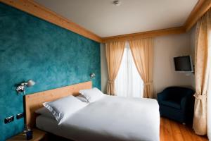 Postelja oz. postelje v sobi nastanitve Hotel Meublè Sertorelli Reit