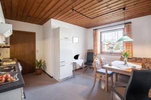 a kitchen and living room with a table and a kitchen and a dining room at Ferienwohnung Brugger 6 Personen in Kaltenbach