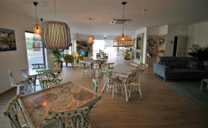 a living room with tables and chairs and a couch at Authentic Tavira Hotel in Tavira