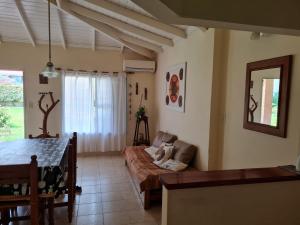 a living room with a couch and a table at Casa Anémona in Merlo