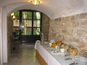 a kitchen with a counter with a stone wall at Palacio de la Rambla in Úbeda
