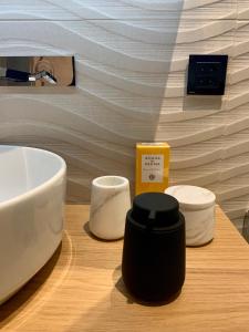 a bathroom counter with a sink and a soap dispenser at New, Luxurious and Central Art Penthouse in Verbier