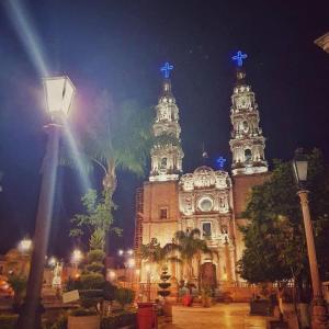 a building with blue crosses on top of it at night at Hotel Zaragoza, San Juan de los Lagos in San Juan de los Lagos