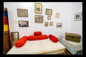 a room with two red pillows on a bed at A Heritage Homestay in Jodhpur