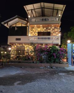 a building with flowers in front of it at night at Mount Bungalows-Mount Paradise-6BHK-PVTPOOL in Lonavala
