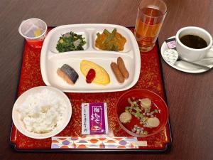 a tray with a plate of food on a table at Hotel Trend Matsumoto in Matsumoto