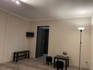 a room with two tables and a lamp and a door at Europa in Kościelec