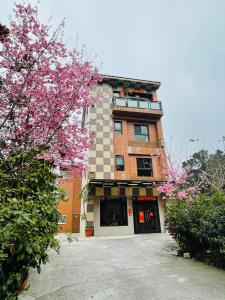 a large brick building with a large window at Sin Ging Hong Resort in Lugu Lake