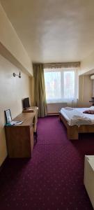 Voodi või voodid majutusasutuse Hotel Olimp toas