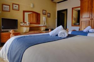 Voodi või voodid majutusasutuse Cornucopia Hotel toas
