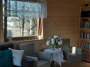 a living room with a table with a vase of flowers at GREEN HOUSE in Krasnopol