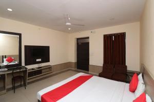 a hotel room with a bed and a television at Central Hotel in Lucknow