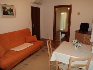 a living room with a couch and a table at Apartments Racetin in Marina