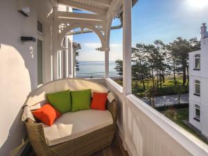 a balcony with a couch and a view of the ocean at Strandvillen Binz - Ferienwohnung mit Meerblick, 2 Schlafzimmern und Balkon SV-008 in Binz
