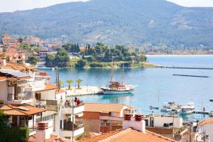 a boat in a body of water with buildings at Kaplanis House in Neos Marmaras